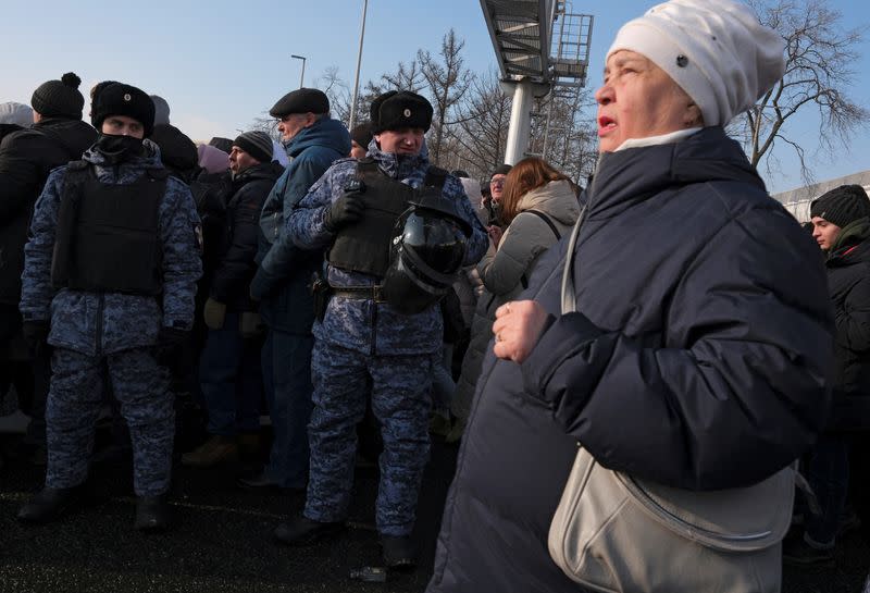 Law enforcement officers stand guard near Luzhniki Stadium ahead of a concert "Glory to the Defenders of the Fatherland" in Moscow