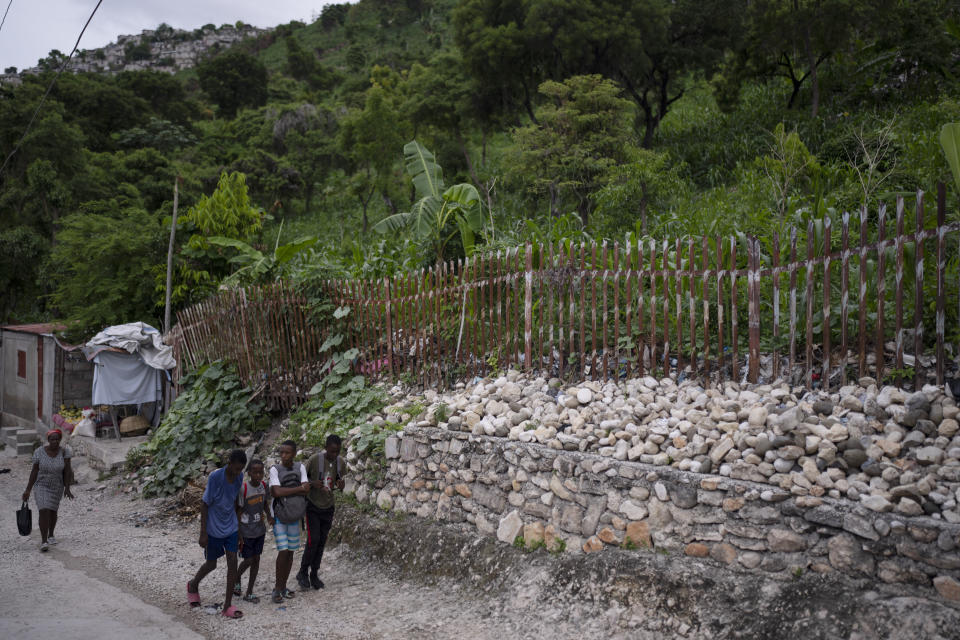 Residents walk through the Turgeau neighborhood of Port-au-Prince, Haiti, Thursday, June 1, 2023. The gang known as "5 Seconds," because that's supposedly how long it takes them to kill someone, is operating in Turgeau. (AP Photo/Ariana Cubillos)