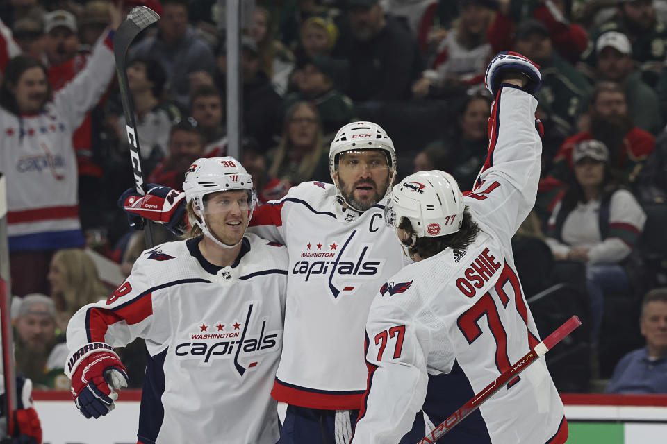 Washington Capitals left wing Alex Ovechkin, center, celebrates with teammates after scoring a goal against the Minnesota Wild during the second period of an NHL hockey game, Sunday, March 19, 2023, in St. Paul, Minn. (AP Photo/Stacy Bengs)