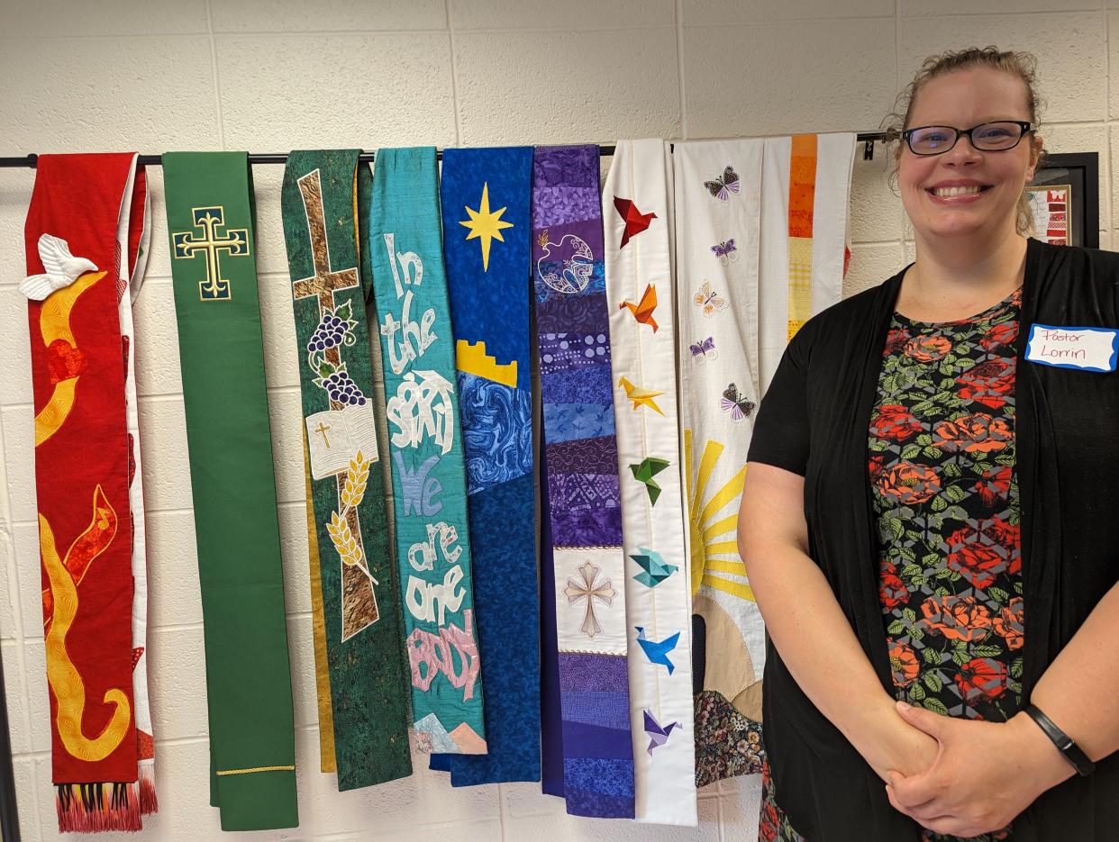 Rev. Lorrin Razdik, 36, the new senior pastor at Grace United Methodist Church in Plain Township, with some of the stoles she wears during worship. Like many clergypersons, Razdik is seeking ways to minister in an increasingly divided country.