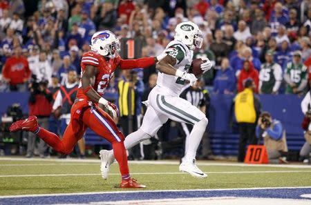 Sep 15, 2016; Orchard Park, NY, USA; New York Jets running back Matt Forte (22) runs the ball in for a touchdown while being defended by Buffalo Bills strong safety Aaron Williams (23) during the second half at New Era Field. The Jets beat the Bills 37 to 31. Mandatory Credit: Timothy T. Ludwig-USA TODAY Sports