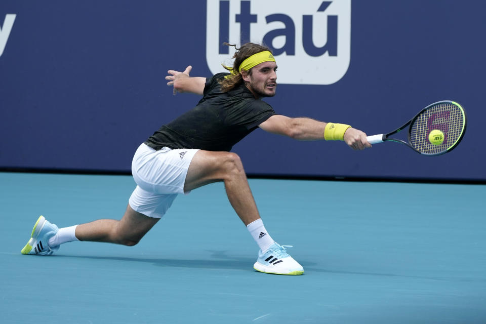 Stefanos Tsitsipas of Greece returns to Hubert Hurkacz of Poland during the quarterfinals of the Miami Open tennis tournament, Thursday, April 1, 2021, in Miami Gardens, Fla. Hurkacz won 2-6, 6-3, 6-4. (AP Photo/Lynne Sladky)