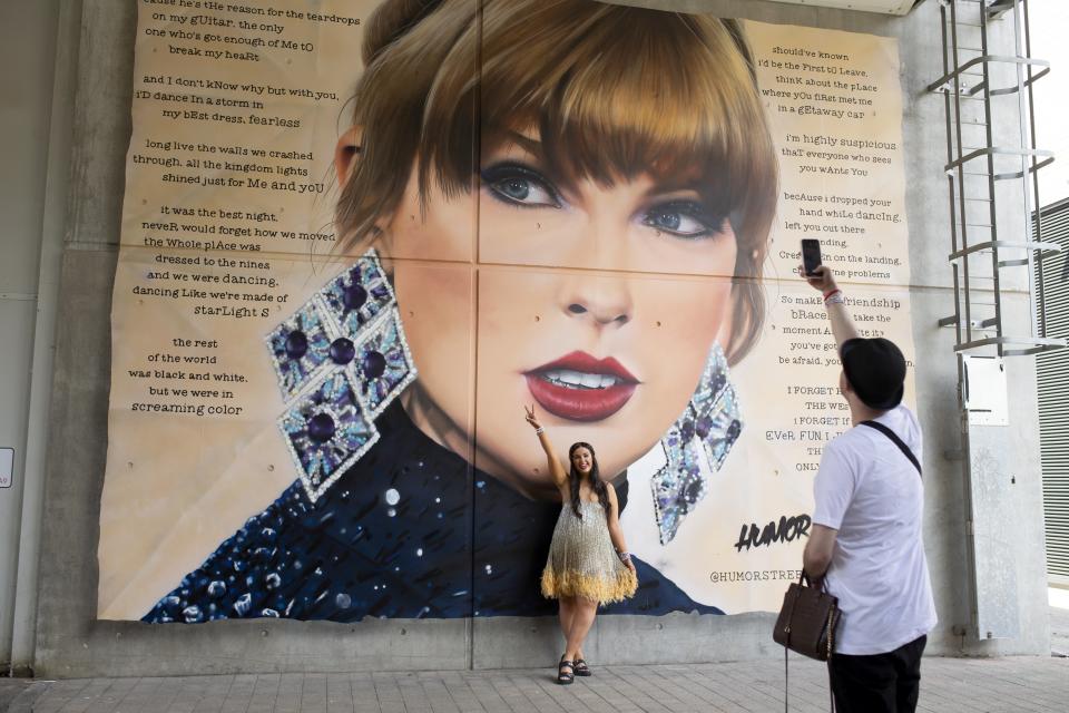 A fan poses in June in front of a mural of Taylor Swift at Wembley Stadium in London (Charlotte Coney/PA) (PA Wire)