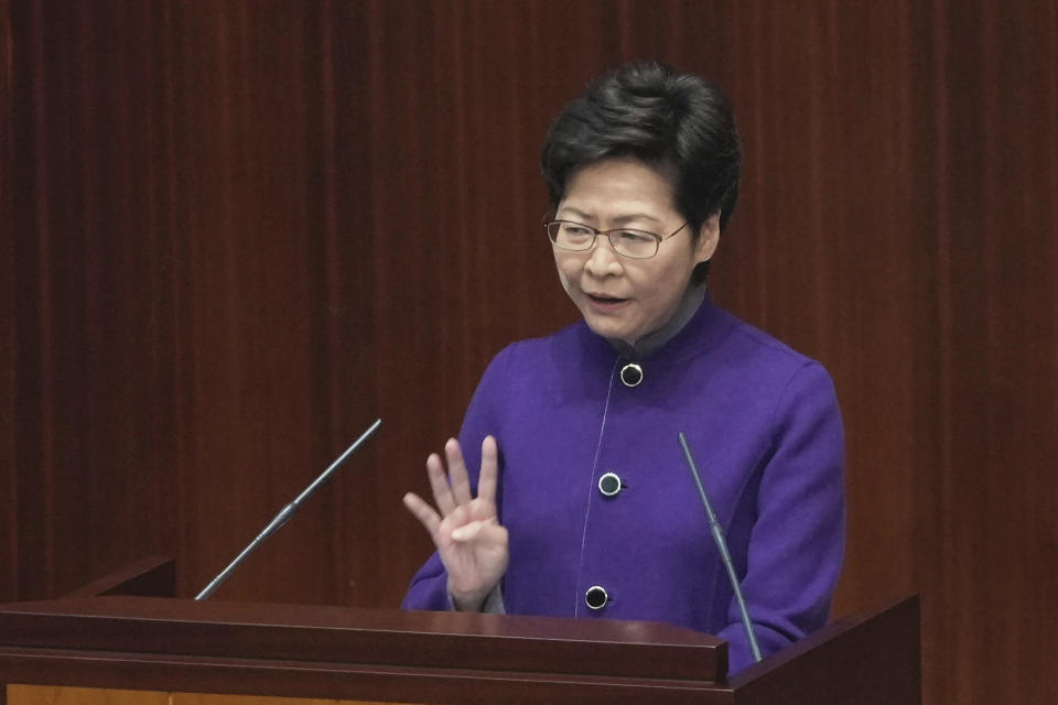 FILE - Hong Kong Chief Executive Carrie Lam speaks during a question and answer session at the Legislative Council in Hong Kong, Wednesday, Jan. 12, 2022. Hong Kong is cutting the length of mandatory quarantine for people arriving from overseas from 21 to 14 days, even as the southern Chinese city battles a new surge in COVID-19 cases. (AP Photo/Kin Cheung, File)