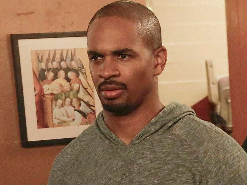 Damon Wayans Jr. as Coach wearing a gray sweatshirt looking confused