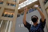 A pro-democracy demonstrator raises his hands up as a symbol of the "Five demands, not one less" demands during a protest against Beijing's plans to impose national security legislation in Hong Kong