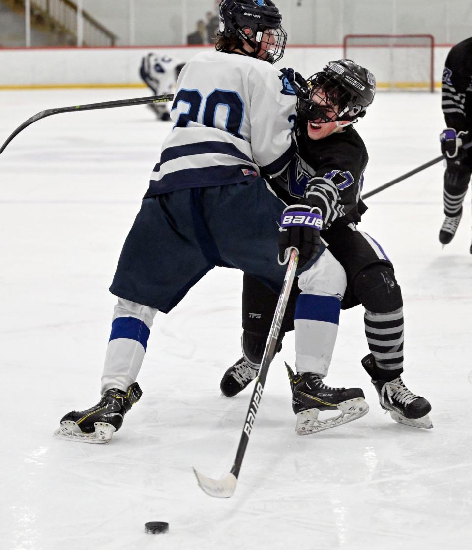 Silas Ohman of Sandwich checks Nick BenDavid of Martha's Vineyard off the puck on Feb. 15, 2023.