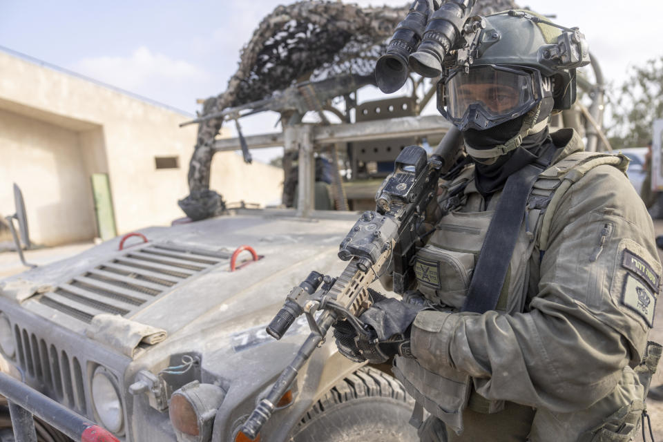 An Israeli soldier holds a machine gun near the Israeli-Gaza border in southern Israel before he enters Gaza Strip, Wednesday, May 1, 2024. (AP Photo/Ohad Zwigenberg)