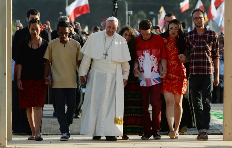 Pope Francis passes the Door of Mercy with youth representatives at Campus Misericordiae on July 30, 2016 in Brzegi as part of the World Youth Days