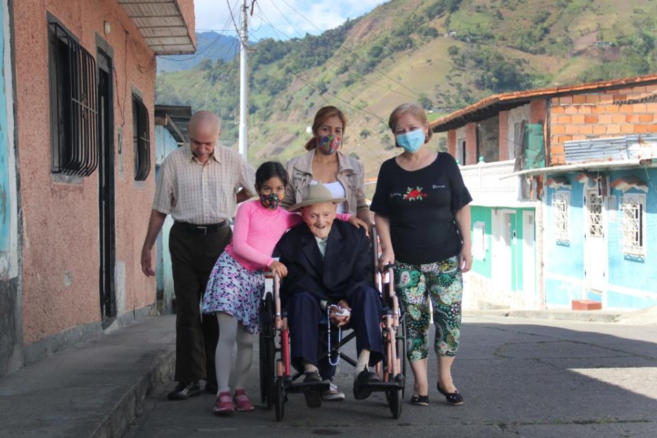 Perez poses with his family in the streets of San José de Bolivar, Venezuela, where he lived right before his death. NurPhoto via Getty Images