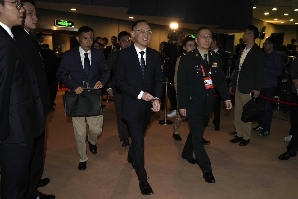 Nong Rong, Assistant Minister of Foreign Affairs of China, center left, arrives for the 10th Beijing Xiangshan Forum in Beijing, Tuesday, Oct. 31, 2023. Singapore's defense minister Ng Eng Hen called on China, as a dominant power in Asia, to take the lead in reducing tensions by being a benevolent one, warning that military conflict like the wars in Ukraine and Gaza would be devastating to the region's future. (AP Photo/Ng Han Guan)