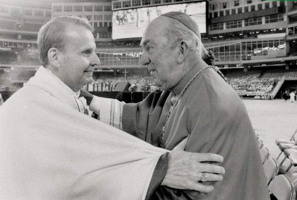 October 15, 1989: Seated far from the three platforms and the clergymen on SkyDome's field, worshippers perched near the top of the SkyDome were consoled by Toronto Bishop Terence Finlay. (Photo by Doug Griffin/Toronto Star via Getty Images)