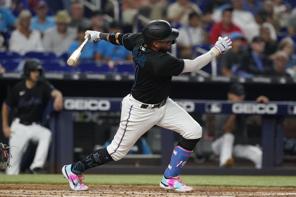 Miami Marlins' Miguel Rojas follows through on a double during the second inning of the team's baseball game against the New York Mets, Friday, Sept. 9, 2022, in Miami. (AP Photo/Marta Lavandier)