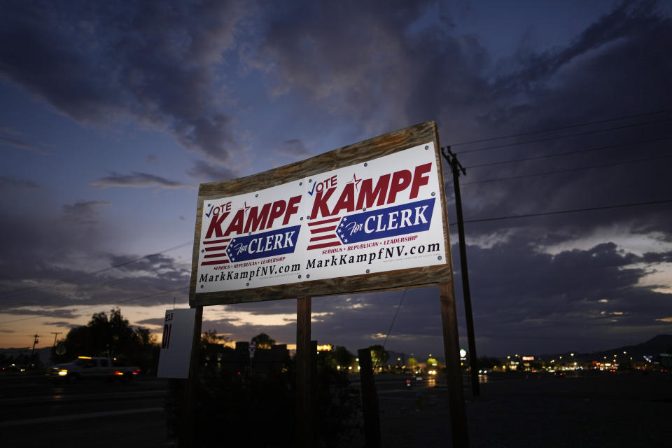 Signs for Nye county clerk candidate Mark Kampf hang along a road July 18, 2022, in Pahrump, Nev. (AP Photo/John Locher)