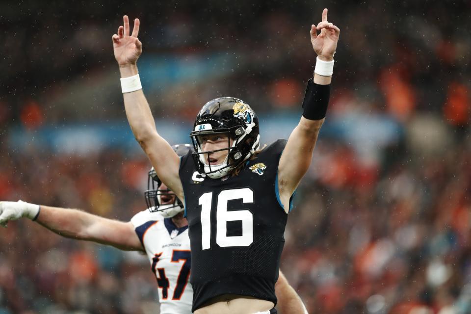 Jacksonville Jaguars quarterback Trevor Lawrence (16) celebrates after a touchdown during an NFL football game against the Denver Broncos at Wembley Stadium in London, Sunday, Oct. 30, 2022. (AP Photo/Steve Luciano)