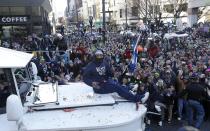 Seattle Seahawks' running back Marshawn Lynch throws pieces of candy while riding on the hood of a vehicle during the Super Bowl champions parade, Wednesday, Feb. 5, 2014, in Seattle. The Seahawks defeated the Denver Broncos 43-8 in NFL football's Super Bowl XLVIII on Sunday. (AP Photo/Ted S. Warren)
