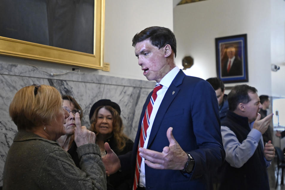 Republican U.S. Senatorial candidate Sam Brown talks with supporter as he arrives to files his paperwork to run for the Senate, Thursday, March 14, 2024, at the State Capitol in Carson City, Nev. Brown is seeking to replace incumbent U.S. Sen. Jacky Rosen. (AP Photo/Andy Barron)