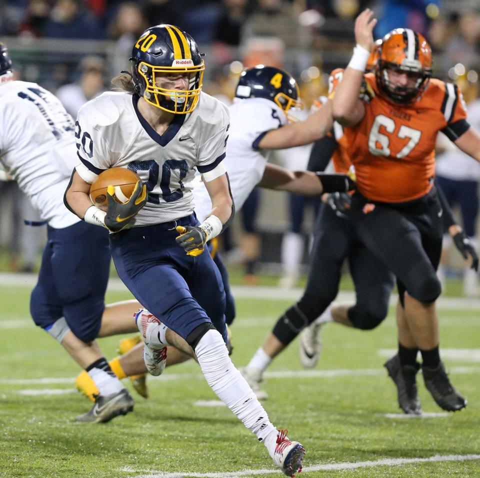 Kirtland's Gage Sullivan carries the ball during a Division V state title game loss to Versailles in 2021.