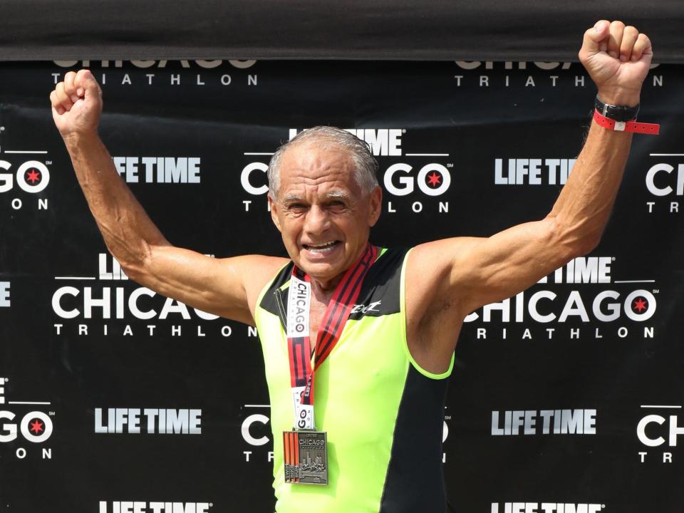 Dr. Joseph Maroon raises his fists in victory at the Lifetime Chicago Triathlon.