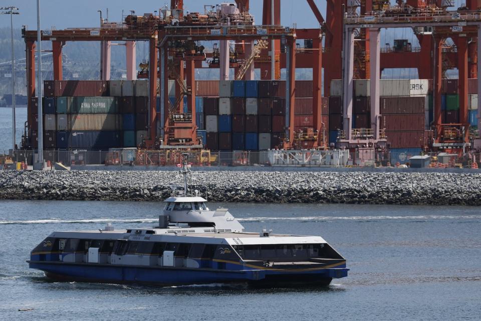 A commuter Seabus passes idle containers during a strike by the International Longshore and Warehouse Union Canada (ILWU) at Canada's busiest port of Vancouver on July 11, 2023. 