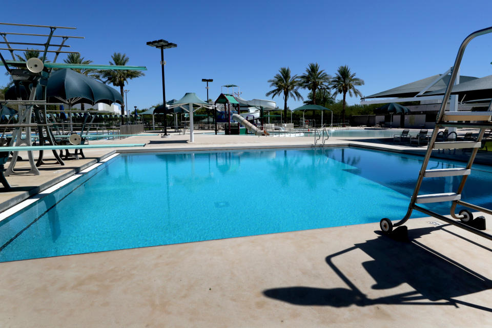 A water park sits idle despite temperatures over 100 degrees Tuesday, June 30, 2020, in Chandler, Ariz. Arizona Gov. Doug Ducey has shut down bars, movie theaters, gyms and water parks amid a dramatic resurgence of coronavirus cases. (AP Photo/Matt York)