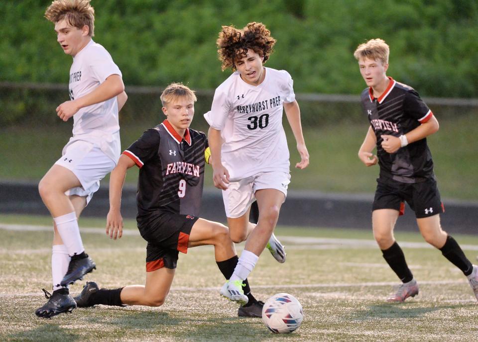 Fairview High School junior Mason Melaragno (9) and Mercyhurst Prep sophomore Alejandro Vazquez (30) compete during a soccer game in Fairview Township on Oct. 3, 2023.