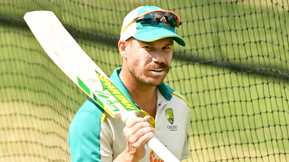 David Warner (pictured) carrying a bat during training at the nets.