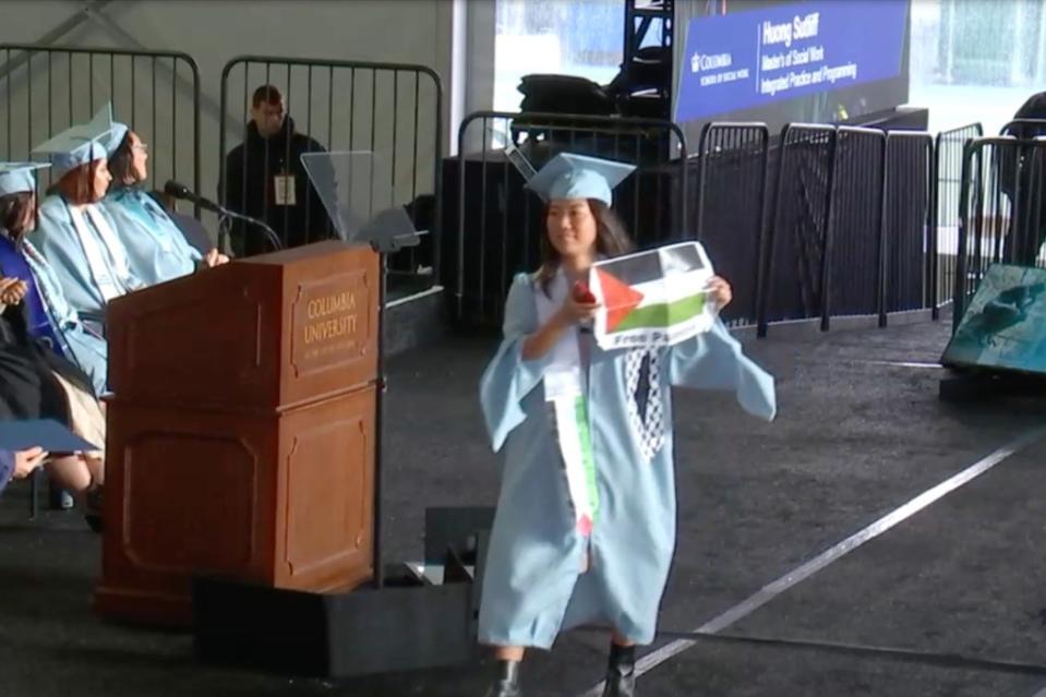 Huong Sutliff waved a Palestinian flag flyer as she accepted her degree. Columbia University