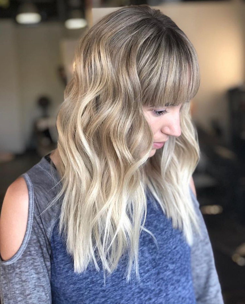 Woman with choppy hair cut and blunt bangs 