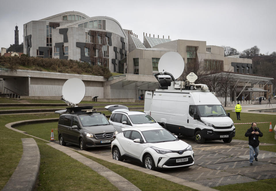 Media outside the Scottish Parliament building as First Minister of Scotland Nicola Sturgeon is due to give evidence to the Committee on the Scottish Government Handling of Harassment Complaints, at Holyrood in Edinburgh, Scotland, Wednesday March 3, 2021. The inquiry is investigating the government’s handling of sexual harassment allegations against former leader Alex Salmond, and allegations that Sturgeon misled parliament. (Jeff J Mitchell/PA via AP)