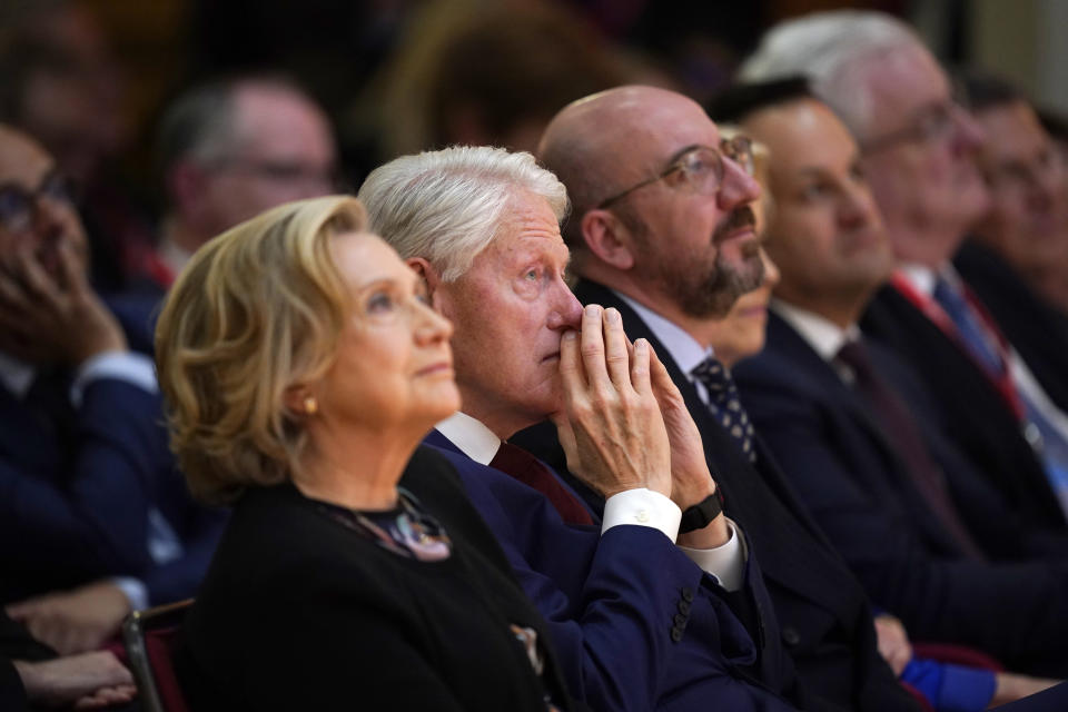 Former US president Bill Clinton, second left, and former US secretary of state Hillary Clinton listen to speakers during the international conference to mark the 25th anniversary of the Belfast/Good Friday Agreement, at Queen's University Belfast, in Belfast, Wednesday April 19, 2023. (Niall Carson/Pool Photo via AP)