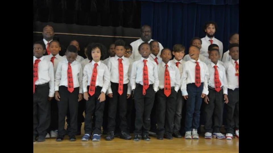 Holmes Elementary School math teacher Abe Coleman with some of the students he had mentored as part of his leadership role with the 5000 Role Models of Excellence Program at the Liberty City School.