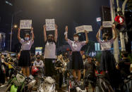 School children and supporters of pro-democracy protesters, display placards during a rally at a major intersection next to the German Embassy in central Bangkok, Thailand Monday, Oct. 26, 2020. As lawmakers debated in a special session in Parliament that was called to address political tensions, the students-led rallies were set to continue with a march through central Bangkok Monday evening to the German Embassy, apparently to bring attention to the time King Maha Vajiralongkprn spends in Germany. Placards from left read: "My future, can I choose it by myself, Have to study and disperse dictatorship at the same time, very brave, very good, Thank you." (AP Photo/Gemunu Amarasinghe)