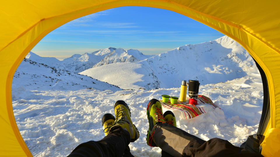 winter camping: looking out from a tent in winter