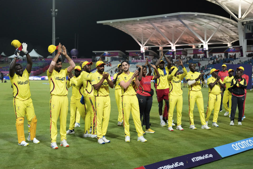 Uganda players acknowledge the support of the fans at the end of an ICC Men's T20 World Cup cricket match against New Zealand at the Brian Lara Cricket Academy in Tarouba, Trinidad and Tobago, Friday, June 14, 2024. (AP Photo/Ramon Espinosa)