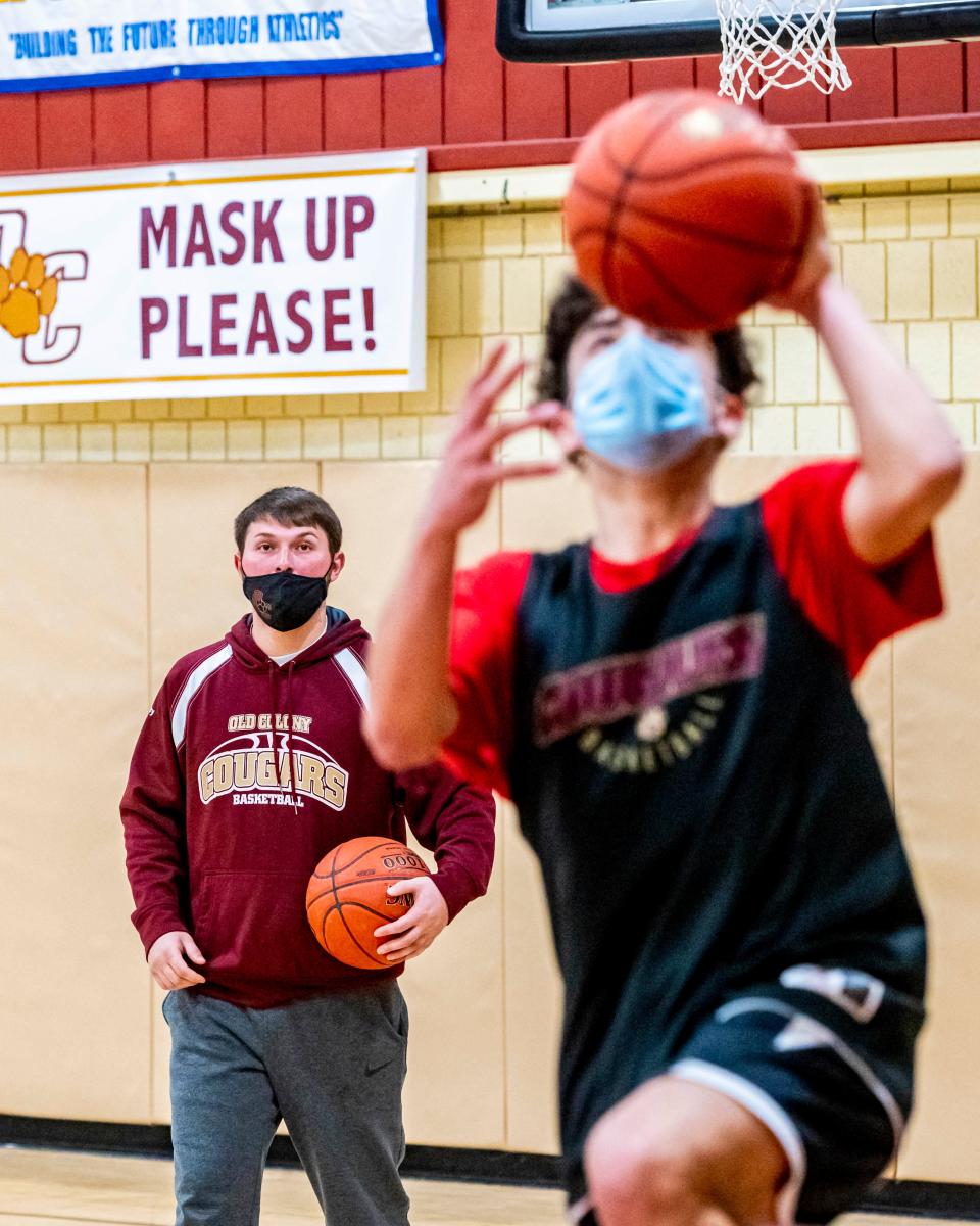 Old Colony assistant coach Paul Soucy helps the team with driving to the basket.