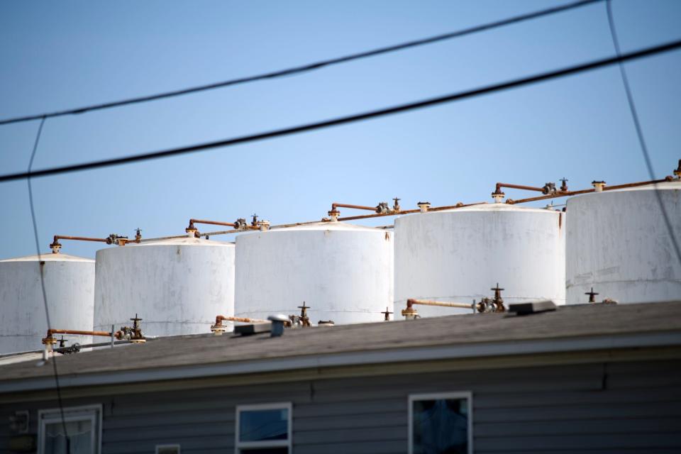 A row of tanks looms above an office building at K-Solv's chemical distribution facility.