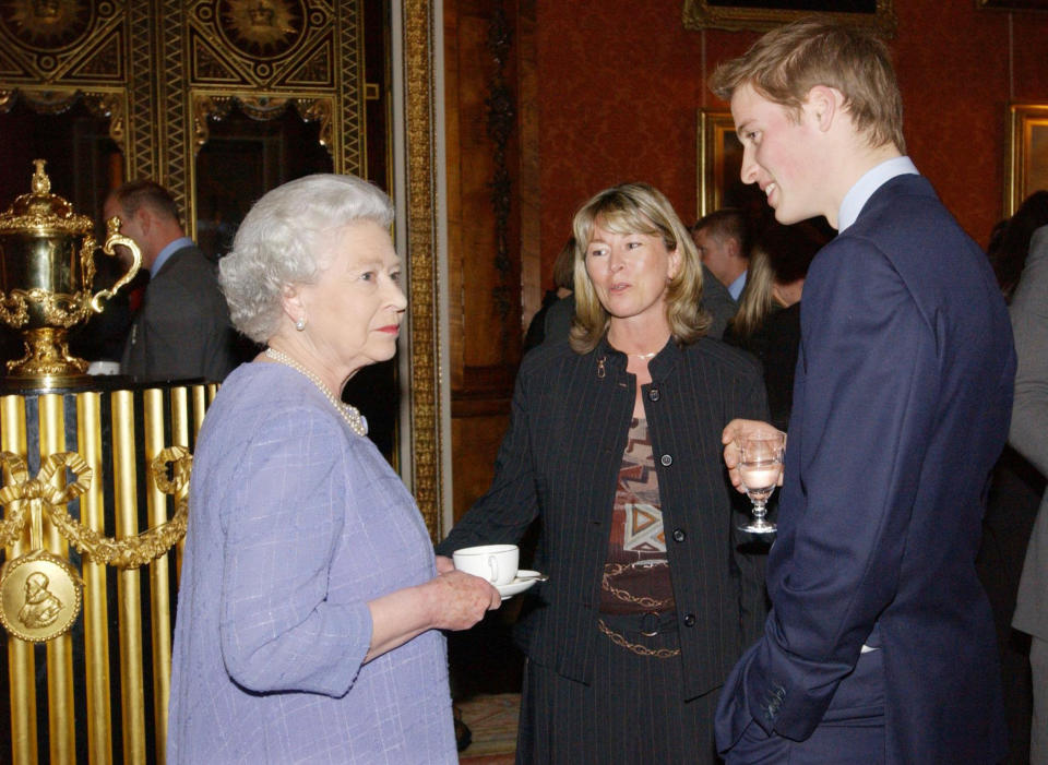 Britain's Queen Elizabeth II and Prince William meet the England Rugby coach Clive Woodward's wife, Jayne Woodward, at Buckingham Palace, London. Earlier the squad had paraded the William Ellis trophy through the West End in a procession of open-topped buses. 