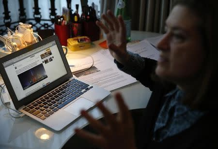 Ursula Gauthier, a French journalist of the weekly l'Obs news magazine speaks as she shows her article about Chinese government's treatment of its Muslim Uighur minority in the northwestern region of Xinjiang, at an interview with Reuters, at her home in Beijing, China December 29, 2015.REUTERS/Kim Kyung-Hoon