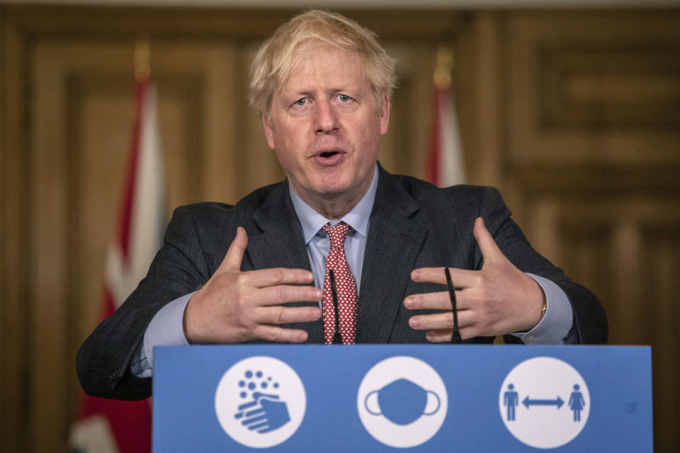 Britain's Prime Minister Boris Johnson gestures, during a coronavirus briefing in Downing Street, London, Wednesday, Sept. 30, 2020. The number of new hospitalizations for COVID-19 and virus deaths in Britain are rising again, although both remain far below their springtime peak. (Jack Hill/Pool Photo via AP)