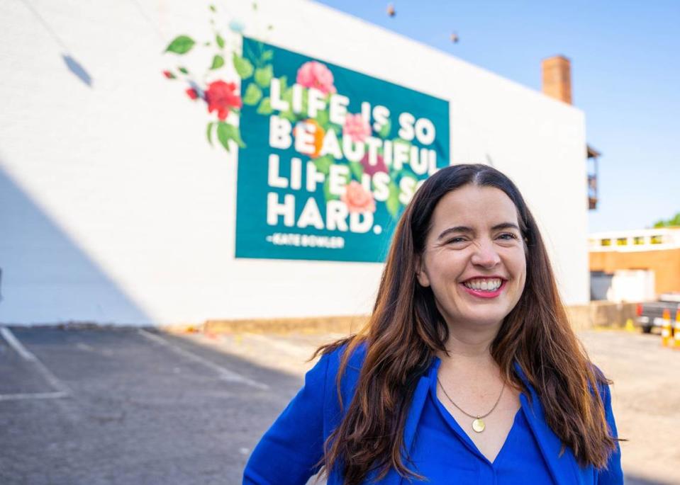 Kate Bowler, Duke Divinity professor, is an author and host of the Everything Happens podcast host. In the summer of 2022, a mural was painted in downtown Durham with the quote “Life is so beautiful. Life is so hard.” The quote comes from her popular New York Times op-ed, written after a life-changing Stage IV colon cancer diagnosis at 35 years old.