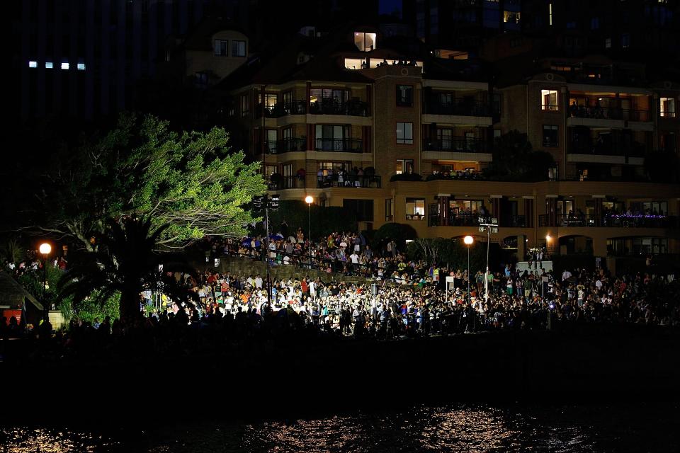 SYDNEY, AUSTRALIA - DECEMBER 31: People watch fireworks around the harbour during New Years Eve celebrations on Sydney Harbour on December 31, 2012 in Sydney, Australia. (Photo by Brendon Thorne/Getty Images)