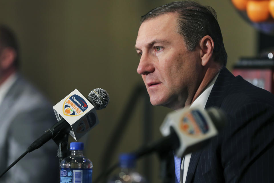 Florida Gators head coach Dan Mullen listens during a news conference for the Orange Bowl NCAA college football game, Sunday, Dec. 29, 2019, in Fort Lauderdale, Fla. Florida plays Virginia in the Orange Bowl on Dec. 30. (AP Photo/Mario Houben)