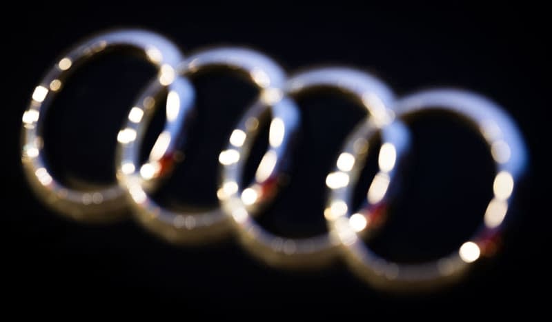 The logo of car manufacturer Audi pictured on a vehicle in the evening. German luxury carmaker Audi has hired away the current chief designer at British competitor Jaguar Land Rover, Massimo Frascella, the company announced on 15 February. Moritz Frankenberg/dpa