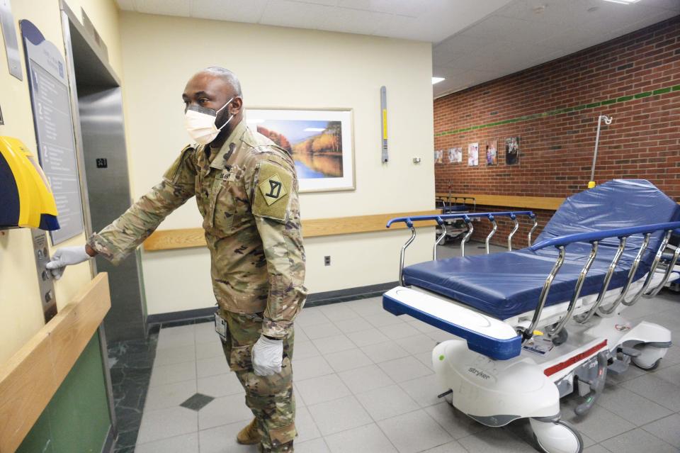 National Guard medical specialist Jay Pierre transports patients at Signature Healthcare Brockton Hospital on Wednesday, Jan. 19, 2022.