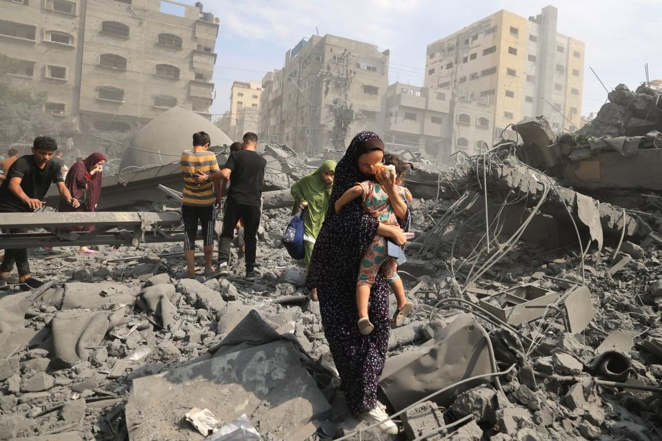 Palestinians evacuate the area following an Israeli airstrike on the Sousi Mosque in Gaza City on Monday. (Mahmud Hams/AFP via Getty Images)