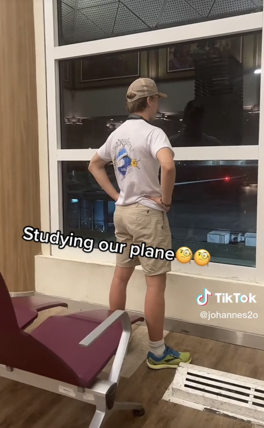 Airport Dad standing at the airport windows with his hands on his hips, with caption "Studying our plane" with monocle emoji