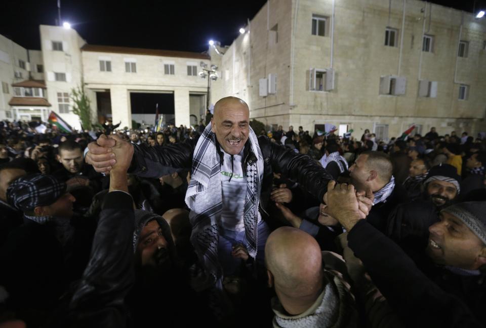 A prisoner released from an Israeli prison is welcomed by relatives in the West Bank city of Ramallah