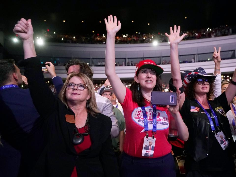 Sen. Kelly Townsend (left) cheers on Trump as he addresses supporters at a Turning Point Action event on July 24, 2021, in Phoenix, AZ.