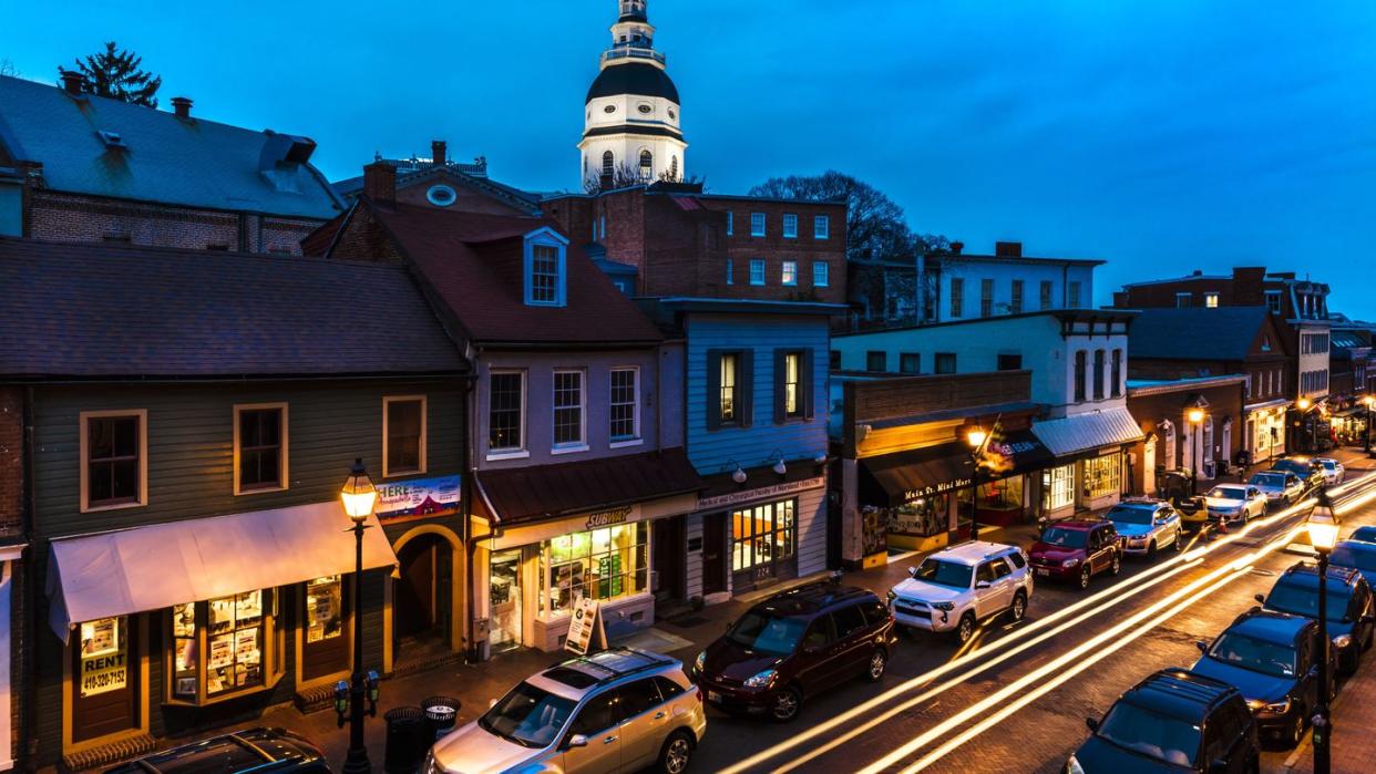 maryland state capitol is seen at dusk above main street annapolis, maryland